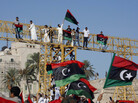 Libyans wave national flags in Tripoli's Green Square, renamed Martyr's Square, during morning prayers Wednesday on Eid al-Fitr, the holiday marking the end of Ramadan. Libyans are also celebrating the ouster of Moammar Gadhafi. Libyans wave national flags in Tripoli's Green Square, renamed Martyr's Square, during morning prayers Wednesday on Eid al-Fitr, the holiday marking the end of Ramadan. Libyans are also celebrating the ouster of Moammar Gadhafi.