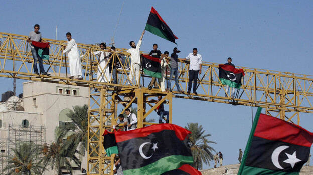Libyans wave national flags in Tripoli's Green Square, renamed Martyr's Square, during morning prayers Wednesday on Eid al-Fitr, the holiday marking the end of Ramadan. Libyans are also celebrating the ouster of Moammar Gadhafi.