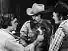 Director Hal Needham lines up a shot with actors Burt Reynolds, Jerry Reed and Happy the dog on the set of the 1977 movie Smokey and the Bandit.
