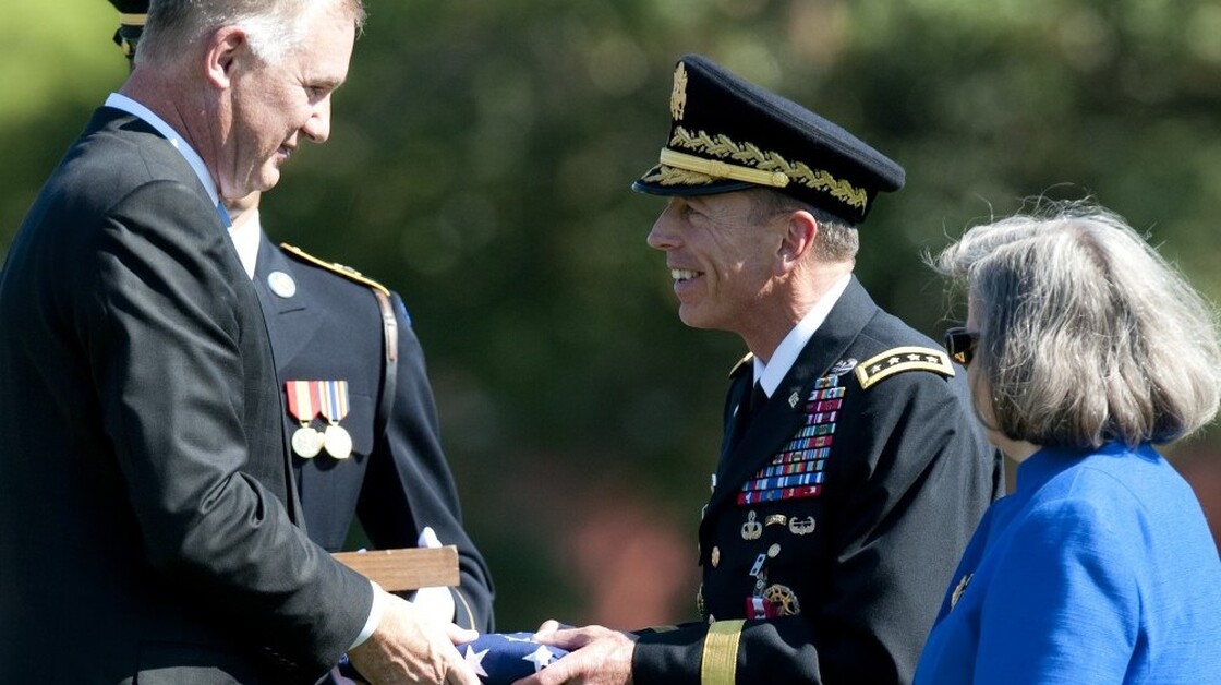 Deputy Defense Secretary William Lynn (left) presents Gen.  David Petraeus with an American flag at his retirement ceremony after 37 years in the Army, in Arlington, Va., on Wednesday. Petraeus will now lead the CIA.