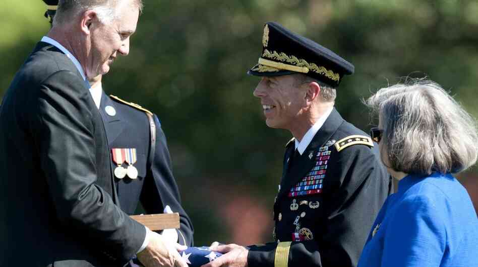 Deputy Defense Secretary William Lynn (left) presents Gen.  David Petraeus with an American flag at his retirement ceremony after 37 years in the Army, in Arlington, Va., on Wednesday. Petraeus will now lead the CIA.