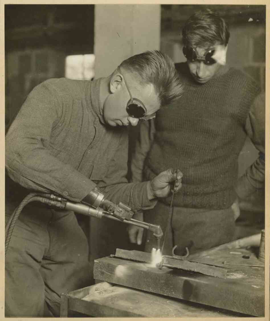A patient practices welding with a prosthetic arm. Occupational therapy has been a part of Walter Reed's mission since its inception in 1909. 