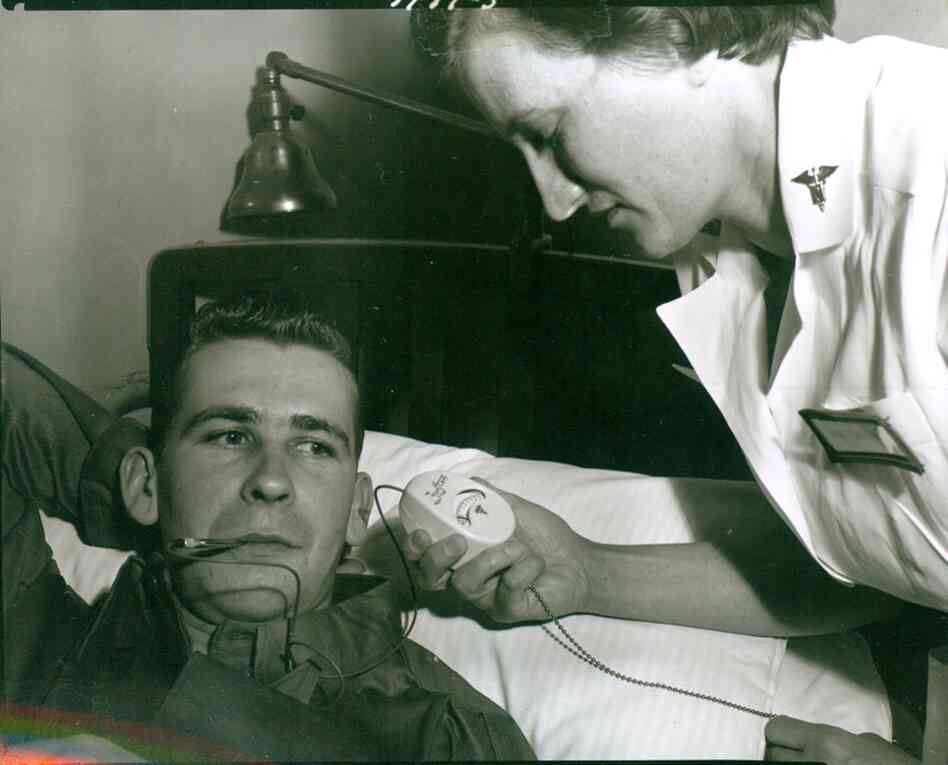 A nurse takes the temperature of a patient at Walter Reed using an electronic thermometer in 1954. The device, developed by Colonel George T. Perkins, an Army dentist stationed at Walter Reed, marked the first design change in a clinical thermometer since the mercury type was introduced in 1867. 
