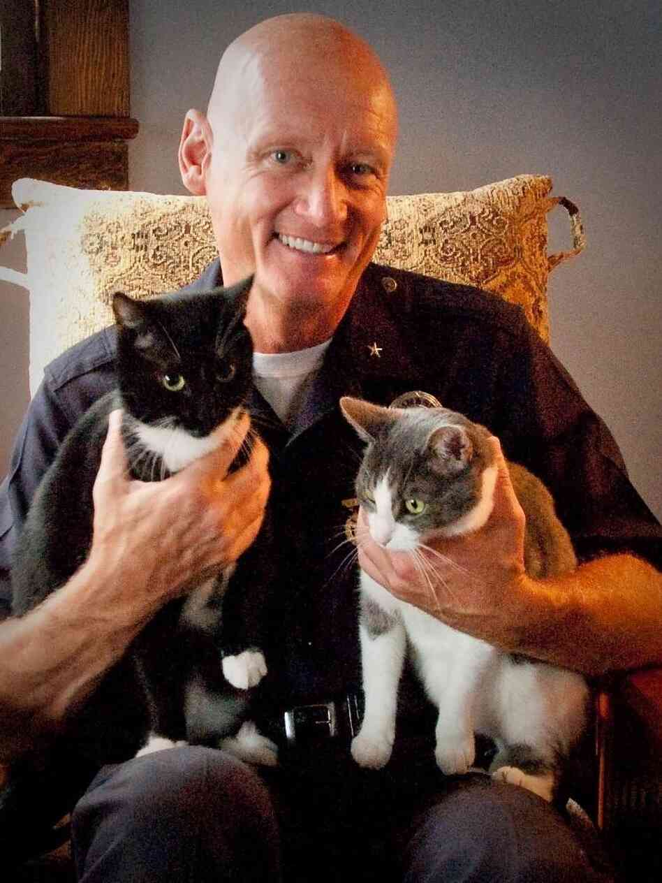 Cmdr. Andrew Smith poses with rescued cats Julia and Rocky. Smith, nicknamed Dr. Dolittle, helps rescue animals that are sold illegally in downtown Los Angeles. Cmdr. Andrew Smith poses with rescued cats Julia and Rocky. Smith, nicknamed Dr. Dolittle, helps rescue animals that are sold illegally in downtown Los Angeles.