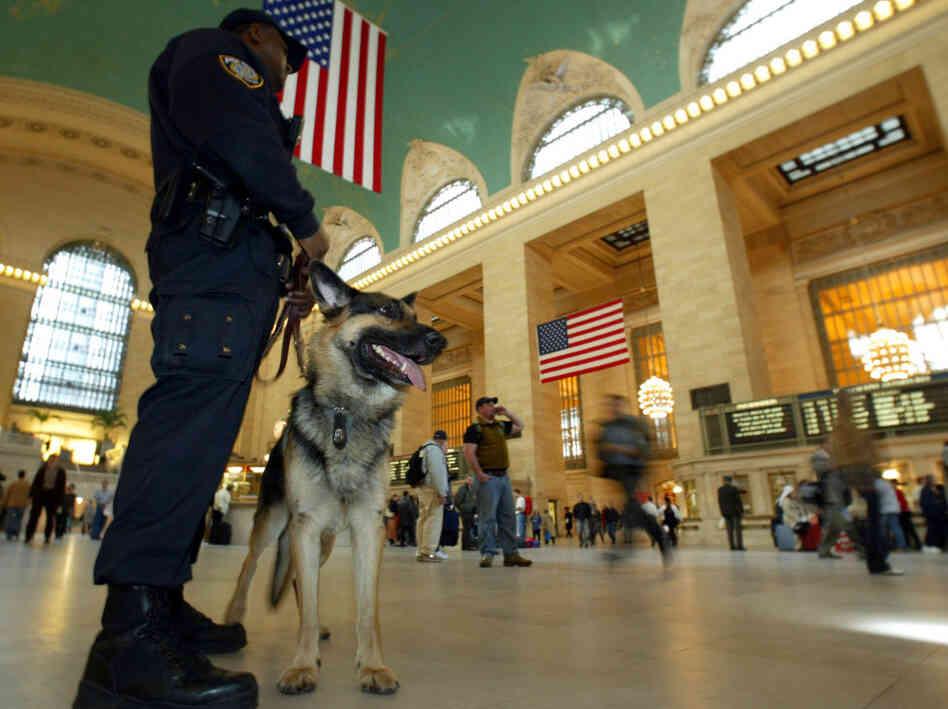 A K-9 police officer and his partner, "Bart," patrol New York's Grand Central Terminal in 2003. Less visible are the clandestine security measures the government has implemented since 2001.