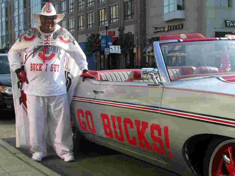 John Chubb, aka Buck I Guy, standing next to his vintage 1970 Chevy Impala — his "Buck I Guy Mobile."