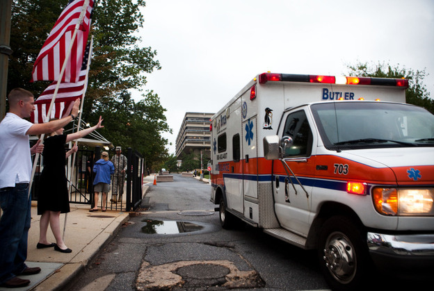 Supporters from the D.C chapter of Free Republic send off the final patients from Walter Reed Army Medical Center on Saturday.