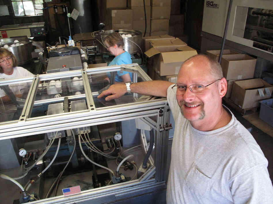 Stephen Mullany, who runs The Wiffle Ball Inc. with his brother David, poses in front of the machine that presses the two plastic ball halves together at a factory in Shelton, Conn. Mullany's grandfather invented the Wiffle Ball in the 1950s. Stephen Mullany, who runs The Wiffle Ball Inc. with his brother David, poses in front of the machine that presses the two plastic ball halves together at a factory in Shelton, Conn. Mullany's grandfather invented the Wiffle Ball in the 1950s.