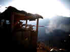 Pfc. Natan Martinez fires a machine gun at an enemy fighting position near the Pakistan border in Afghanistan.