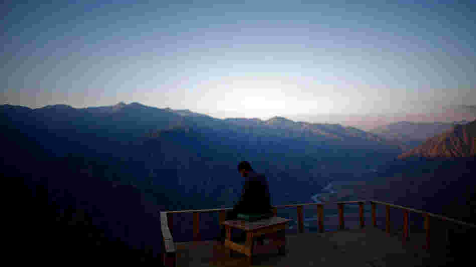 A member of the Afghan Security Guards looks over the Kunar River Valley from Observation Post Mustang in Kunar Province, northeastern Afghanistan. A member of the Afghan Security Guards looks over the Kunar River Valley from Observation Post Mustang in Kunar Province, northeastern Afghanistan.