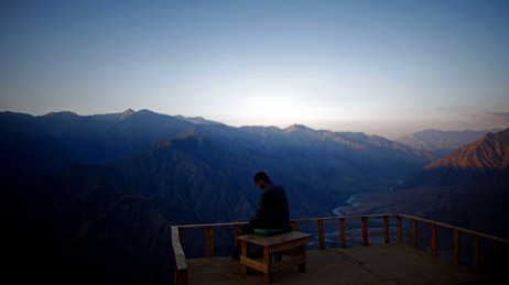 A member of the Afghan Security Guards looks over the Kunar River Valley from Observation Post Mustang in Kunar Province, northeastern Afghanistan. A member of the Afghan Security Guards looks over the Kunar River Valley from Observation Post Mustang in Kunar Province, northeastern Afghanistan.