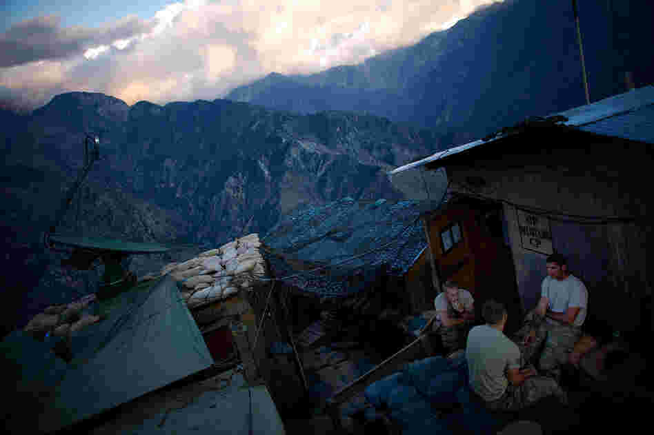 Members of the Army's 2-27th Infantry Regiment from Hawaii talk outside the buildings at Observation Post Mustang in Kunar Province, northeastern Afghanistan.