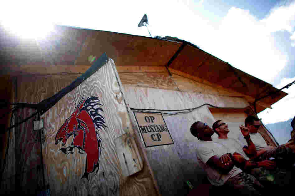 Spc. Jermaine Aikens (left), Sgt. Eric Scharf (center) and Pfc. Michael Montierth (right) talk at Observation Post Mustang.