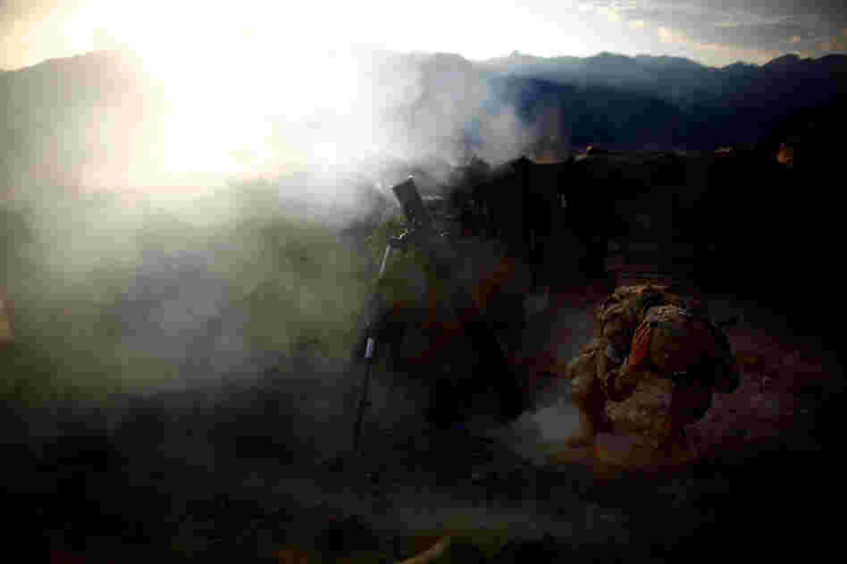 Pfc. Jaworski covers his ears as an explosive round is fired.