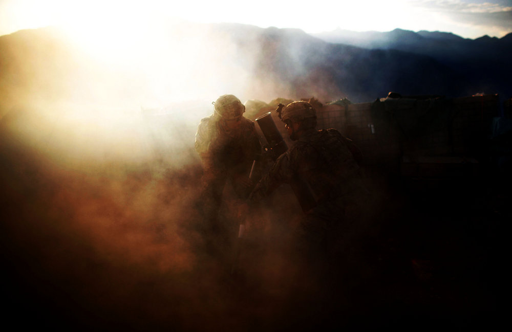 Pfc. Natan Martinez (left) and Spc. Frederick (right) fire an explosive round at a suspected enemy.