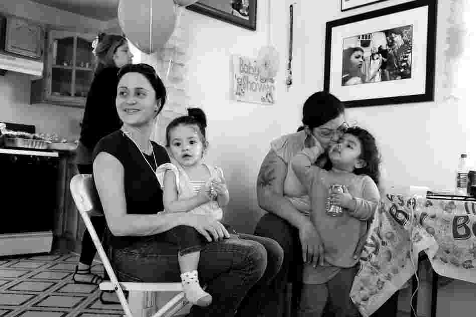 BooBoo (right) kisses her daughter at a baby shower for her twin sons, 2010