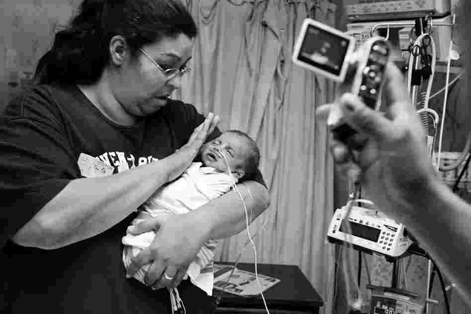 BooBoo in the hospital with her son and her partner, Peter, 2010