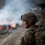 Army Pfc. Brayden Panttaja, 23, of Moscow, Idaho, walks past a pile of burning garbage while descending from a hilltop observation post at Combat Outpost Monti in Kunar province, Afghanistan, on Tuesday.