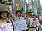 Farmers whose crops were ruined by a nuclear accident protest Aug. 3 at the Tokyo Electric Power Co. Many Japanese are calling for the country to lessen its dependence on nuclear power following the accident six months ago. Farmers whose crops were ruined by a nuclear accident protest Aug. 3 at the Tokyo Electric Power Co. Many Japanese are calling for the country to lessen its dependence on nuclear power following the accident six months ago.