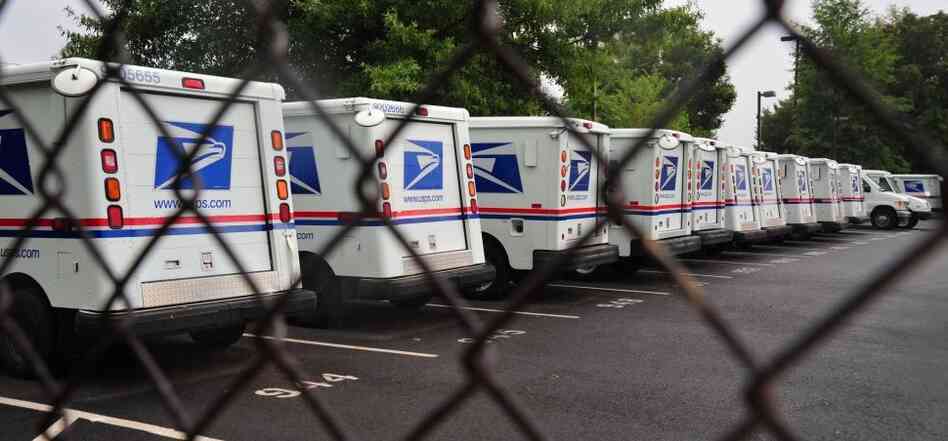 U.S. Postal Service mail delivery trucks sit idle at the Manassas post office in Virginia on Sept. 5.