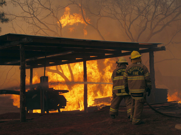Firefighters at a blaze on Highway 71 near Smithville, Texas, on Monday.