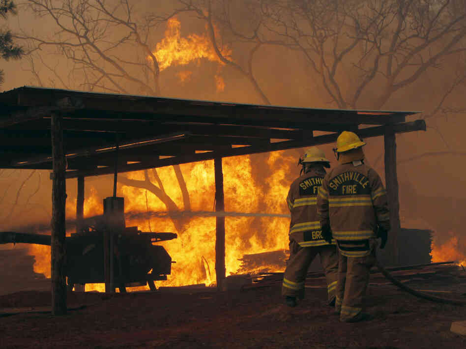 Firefighters at a blaze on Highway 71 near Smithville, Texas, on Monday.