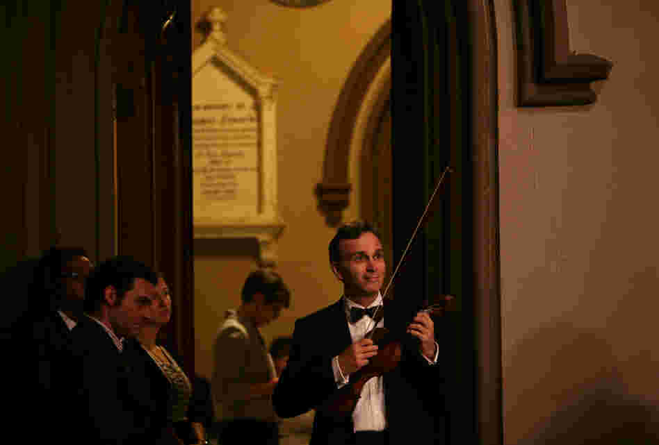 Gil Shaham, violinist, watches the choir while waiting to perform during "Remember to Love: Let Us Love One Another With A Sincere Heart."