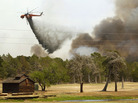 Firefighting helicopters dump water and flame retardant after loading up with water from a pond at Lost Pines Golf Club as they fight a fire in Bastrop State Park on September 6, 2011 in Bastrop, Texas. Firefighting helicopters dump water and flame retardant after loading up with water from a pond at Lost Pines Golf Club as they fight a fire in Bastrop State Park on September 6, 2011 in Bastrop, Texas.