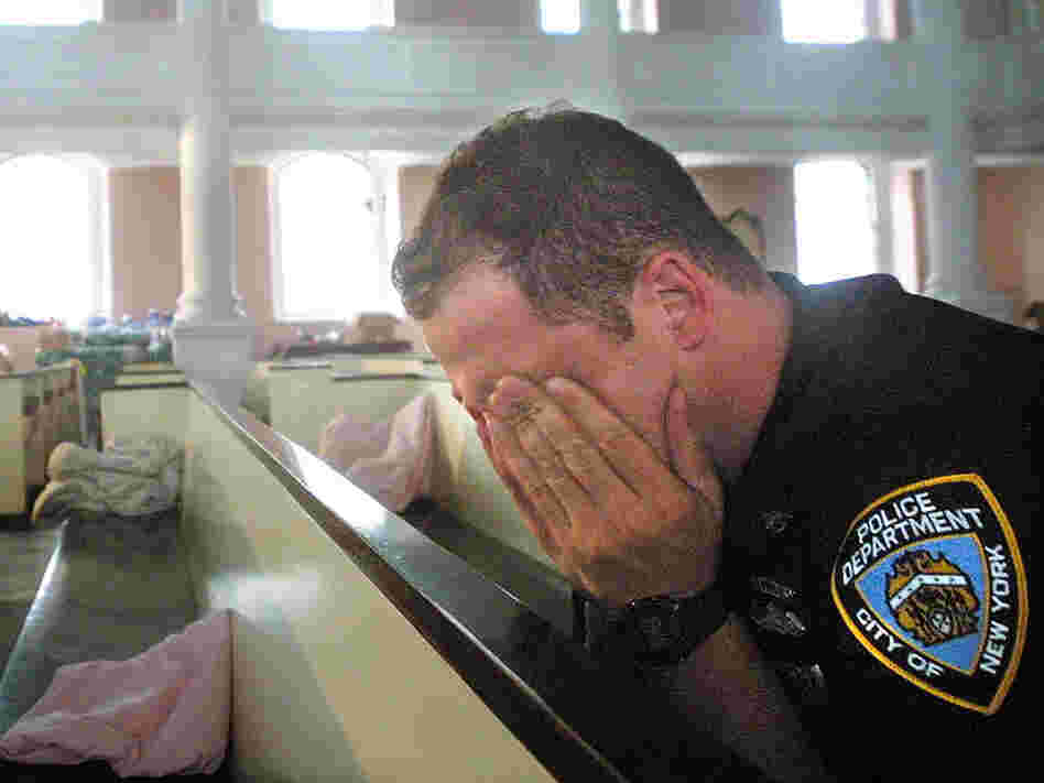 An NYPD police officer takes comfort in St. Paul's Episcopal Chapel, near the site of the World Trade Center attack, September 21, 2001. An NYPD police officer takes comfort in St. Paul's Episcopal Chapel, near the site of the World Trade Center attack, September 21, 2001.