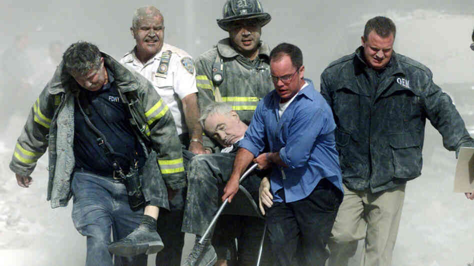 A mortally injured Father Mychal Judge is carried out of the World Trade Center by first responders, including Bill Cosgrove (in white shirt). Cosgrove says, "everybody you see in that picture was saved" from the North Tower's collapse, moments later. A mortally injured Father Mychal Judge is carried out of the World Trade Center by first responders, including Bill Cosgrove (in white shirt). Cosgrove says, "everybody you see in that picture was saved" from the North Tower's collapse, moments later.