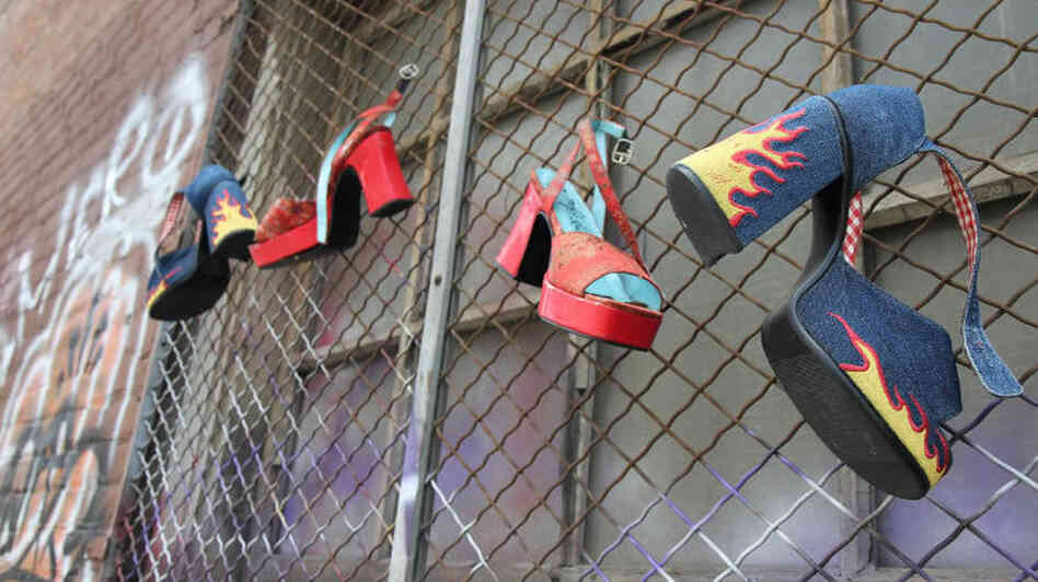 High-heeled shoes  hang from a gated window in an empty alley behind the National Lodge motel. The  Oakland city attorney has filed suit against the motel, arguing that it  knowingly facilitates child sex trafficking.