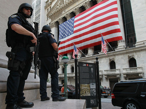 New York City policemen stand guard near the New York Stock Exchange on Friday. Security in New York and Washington has been stepped up based on what the government is calling a credible but unconfirmed threat of a possible car bomb attack. New York City policemen stand guard near the New York Stock Exchange on Friday. Security in New York and Washington has been stepped up based on what the government is calling a credible but unconfirmed threat of a possible car bomb attack.