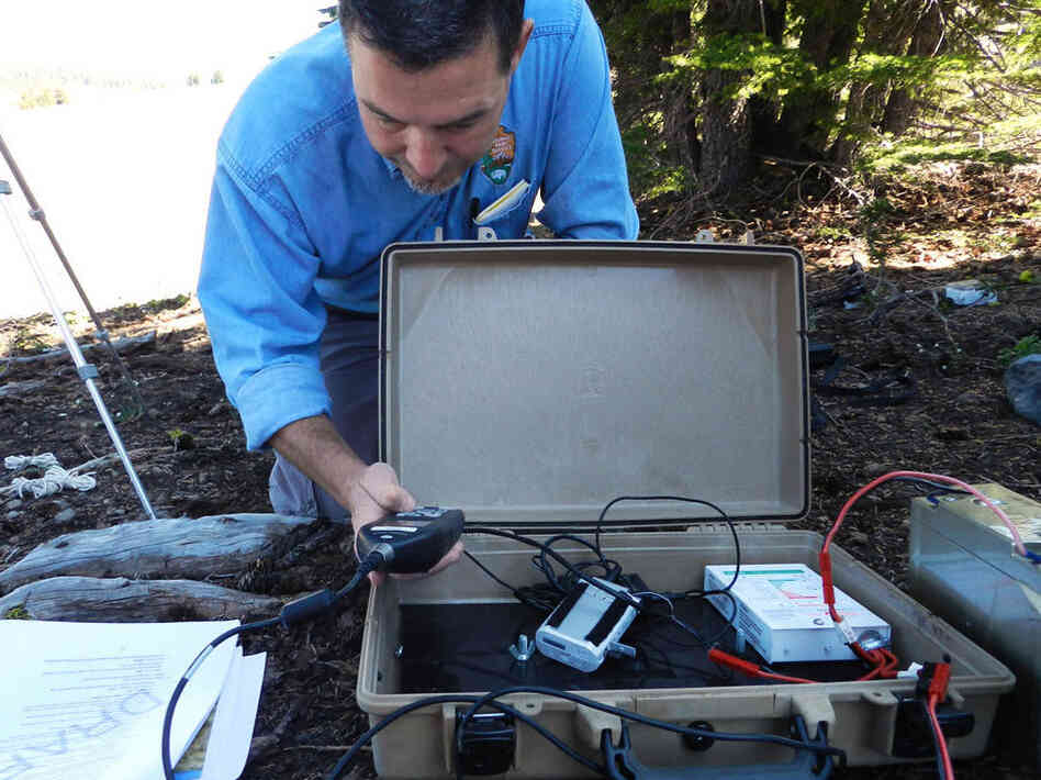 Researcher Chris Wayne sets up recording equipment at Crater Lake. Researcher Chris Wayne sets up recording equipment at Crater Lake.