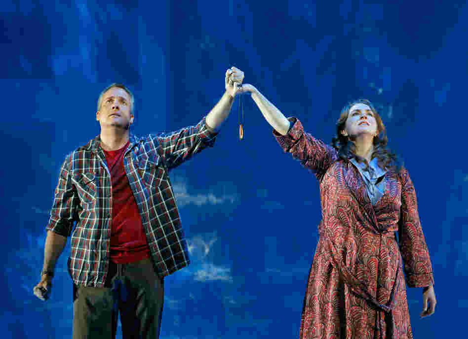 Susan Rescorla (Melody Moore) and Dan Hill together hold Dan's protective talisman near the end of the opera "Heart of a Soldier" at the San Francisco Opera.