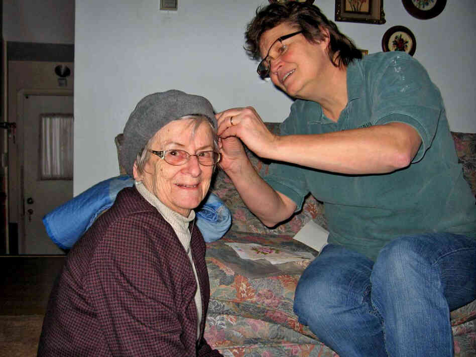 Kate Frego pins the turban of her mother, Aida Essenburg. Before Essenburg died in July of this year, she sat down with a dignity therapist to record the history of  her life in what became a 50-page document.