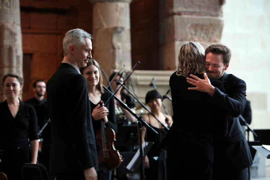 Conductor Ryan McAdams hugs composer William Basinski after a performance of his "Disintegration Loops, dlp 1.1" at the Remembering September 11 Wordless Music Orchestra concert at  The Temple of Dendur in The Metropolitan Museum of Art in Manhattan, NY on September 11, 2011.