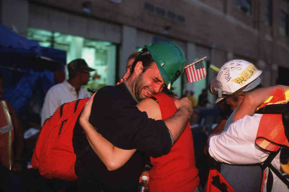 Volunteer rescue workers break down and cry after leaving the World Trade Center site. 