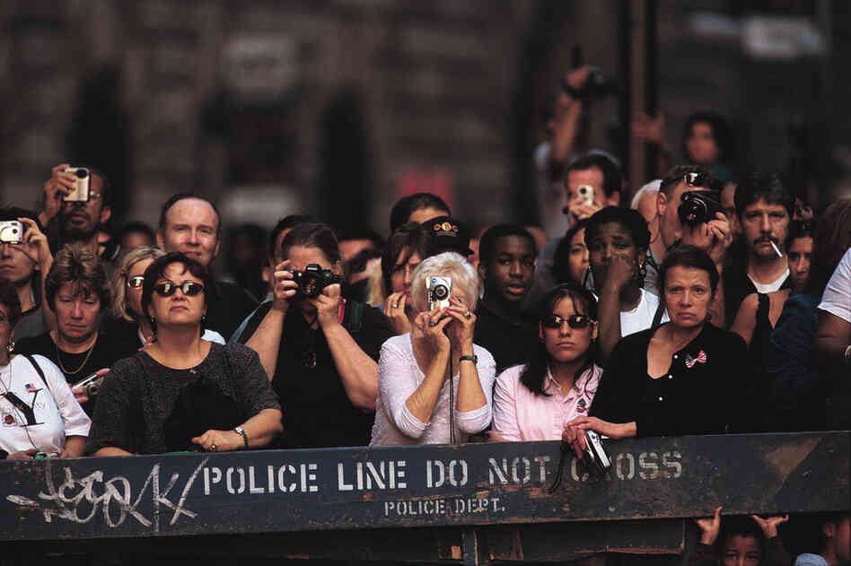 Onlookers watch the clearing work at the remains of the World Trade Center. 