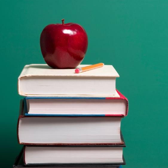 An apple on a stack of books.