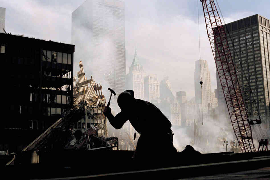 A lone construction worker hammers away at the wreckage of the World Trade Center. 