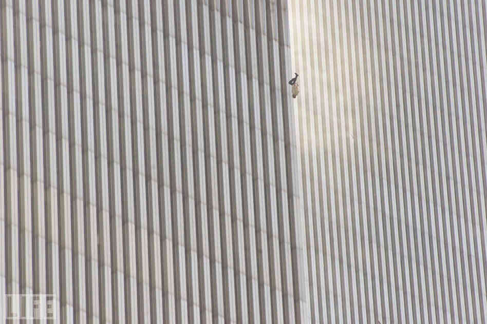 In a scene repeated with terrifying frequency as flames engulfed the tops of the towers, a man falls (or leaps, as was evidently the case with many victims) to his death from the World Trade Center. 
