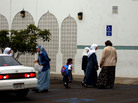 Parents bring their children to school near a mosque at the Islamic Center of San Diego, Sept. 19, 2001. The current head of the center says before Sept. 11 the Muslim community was insular. He now hosts interfaith meetings and participates in community groups. Parents bring their children to school near a mosque at the Islamic Center of San Diego, Sept. 19, 2001. The current head of the center says before Sept. 11 the Muslim community was insular. He now hosts interfaith meetings and participates in community groups.