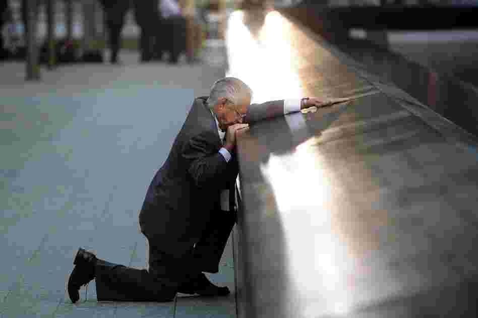 Robert Peraza, who lost his son Robert David Peraza, pauses at his son's name at the 9/11 Memorial. 