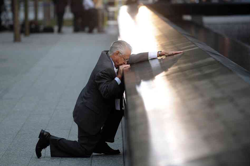 Robert Peraza, who lost his son Robert David Peraza, pauses at his son's name at the 9/11 Memorial. 