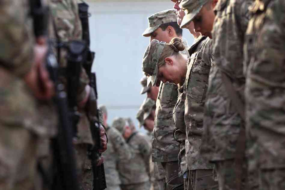 U.S. soldiers pray at an anniversary ceremony at Bagram Air Field in Afghanistan. 
