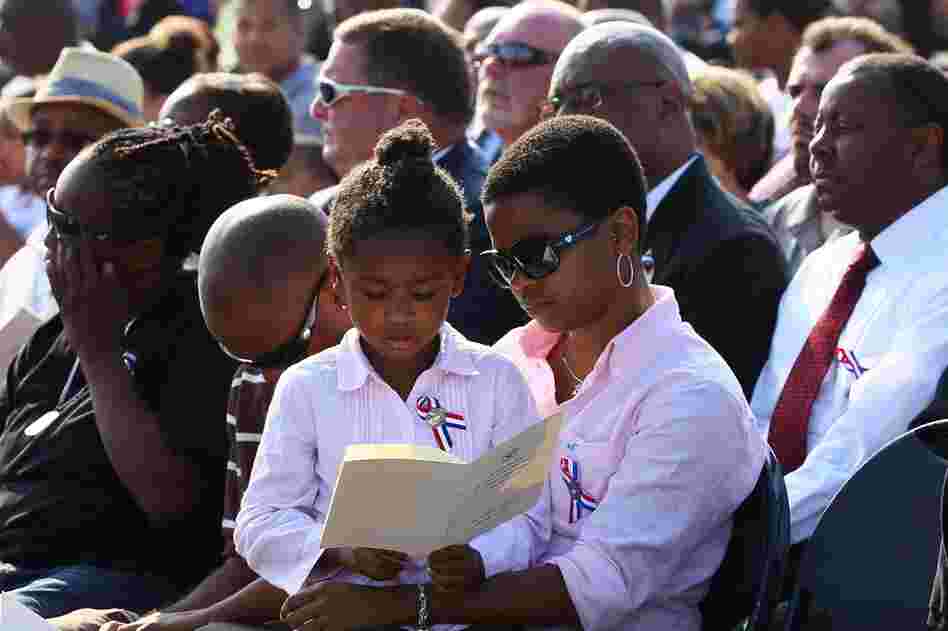 People observe a moment of silence during a ceremony at the Pentagon in Arlington, Va. 