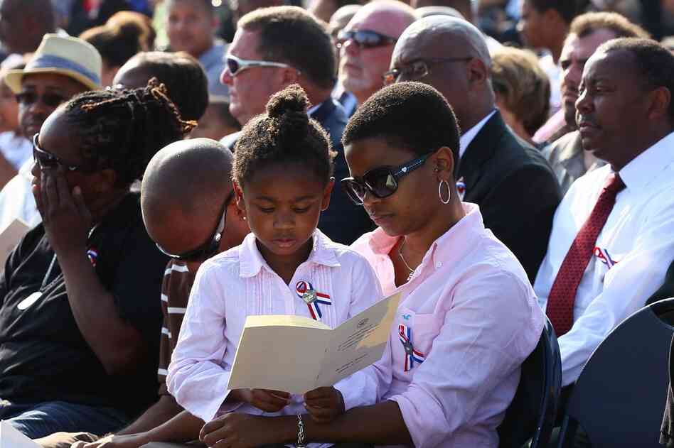 People observe a moment of silence during a ceremony at the Pentagon in Arlington, Va. 