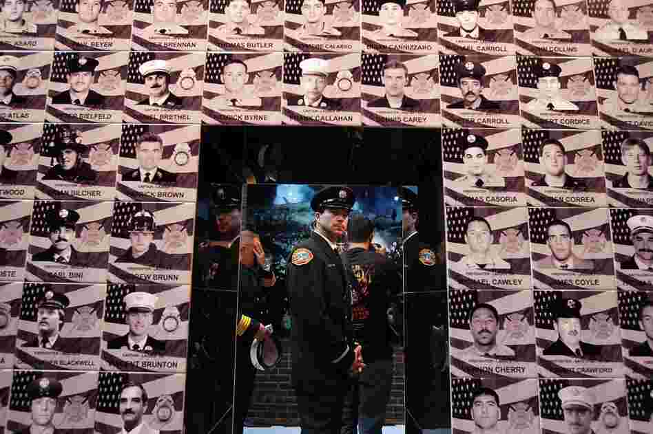 San Diego City firefighter William McLaughlin pauses as he looks at a memorial for the 343 New York firefighters who died during the Sept. 11 attacks, on Sunday in New York City. 