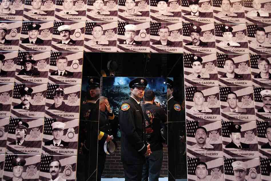 San Diego City firefighter William McLaughlin pauses as he looks at a memorial for the 343 New York firefighters who died during the Sept. 11 attacks, on Sunday in New York City. 