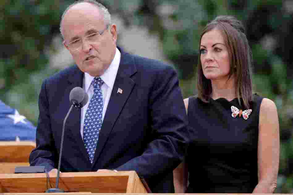 Former New York City Mayor Rudolph W. Giuliani (left) speaks with his wife, Judith Nathan, at his side in New York City. 